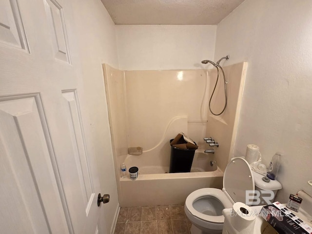 bathroom with toilet, tile patterned flooring, and bathing tub / shower combination