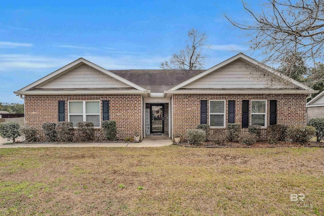 ranch-style house featuring a front lawn and brick siding