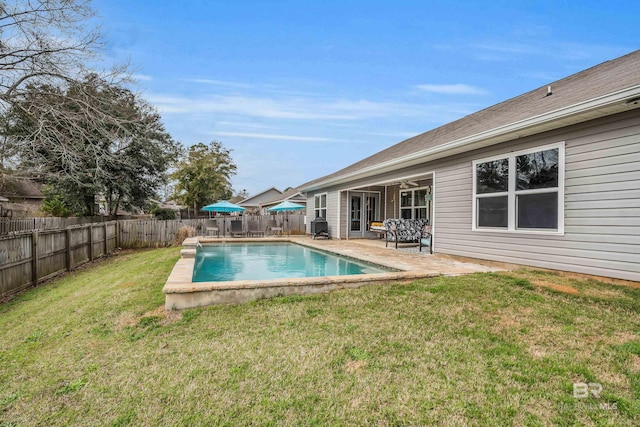 view of swimming pool featuring a patio area, a fenced backyard, a lawn, and a fenced in pool