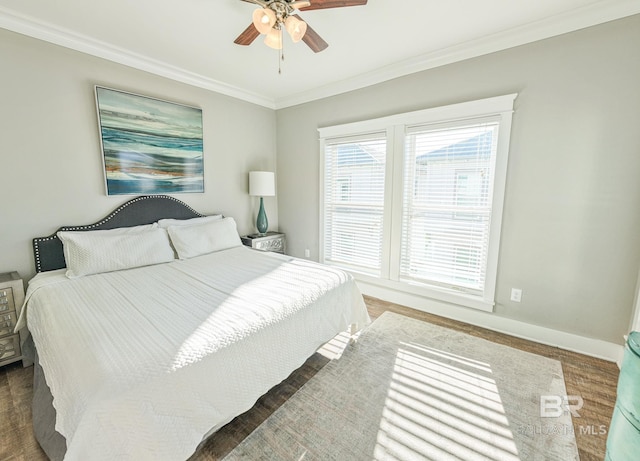 bedroom featuring baseboards, multiple windows, and crown molding