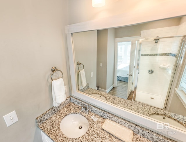 bathroom featuring a stall shower, connected bathroom, and vanity