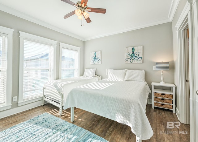 bedroom featuring ceiling fan, baseboards, crown molding, and wood finished floors