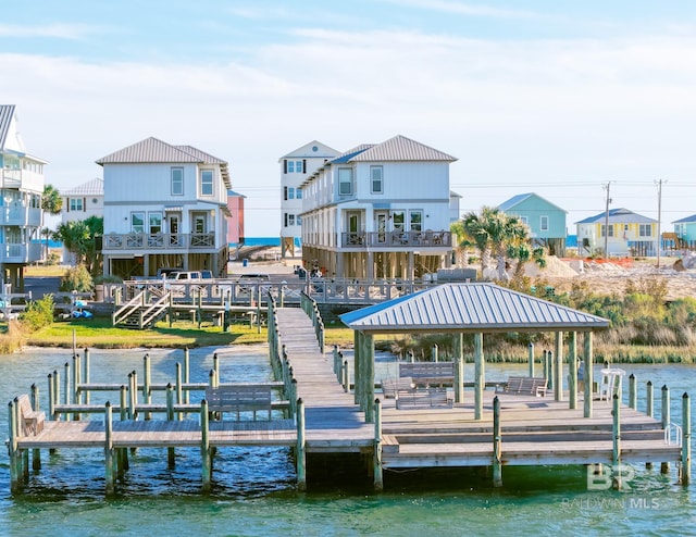 view of dock with a gazebo and a water view