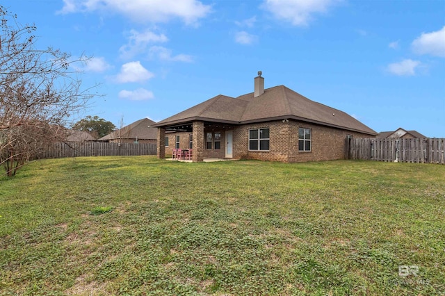 back of property featuring a yard and a patio area