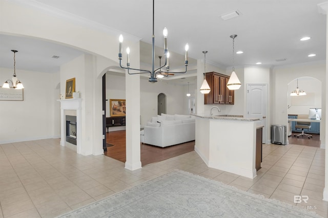 kitchen with light tile patterned flooring, pendant lighting, and an inviting chandelier