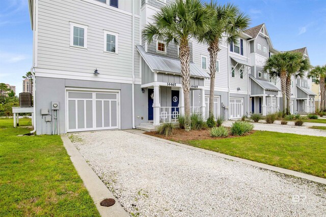 townhome / multi-family property featuring a garage and a front yard