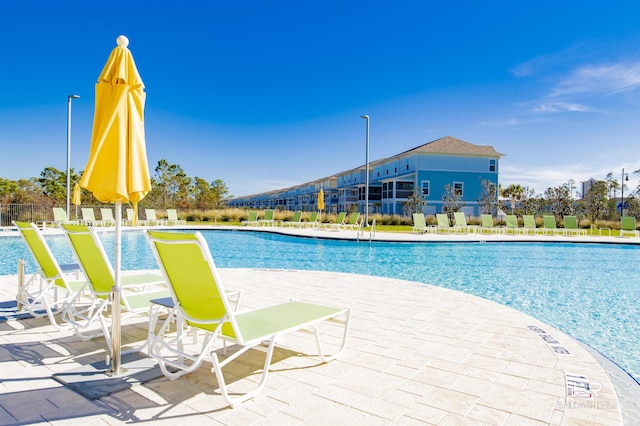 pool featuring a patio area and fence