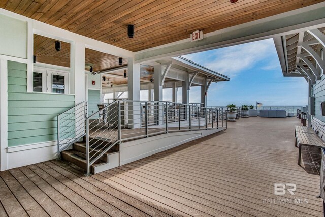 wooden terrace featuring ceiling fan and french doors