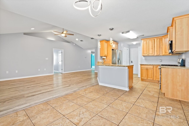 26715 Terry Cove Dr, Orange Beach, AL 36561 - kitchen with stainless steel appliances, open floor plan, light tile patterned floors, ceiling fan, and lofted ceiling