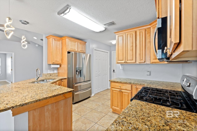26715 Terry Cove Dr, Orange Beach, AL 36561 - kitchen with stainless steel appliances, light brown cabinetry, a sink, a peninsula, and light tile patterned floors