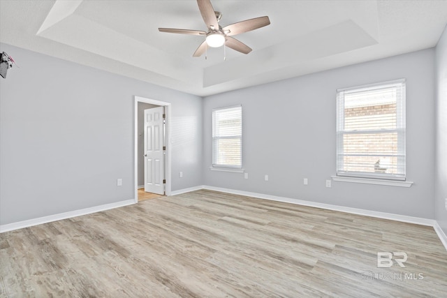 26715 Terry Cove Dr, Orange Beach, AL 36561 - unfurnished room with a raised ceiling, a ceiling fan, light wood-style flooring, and baseboards