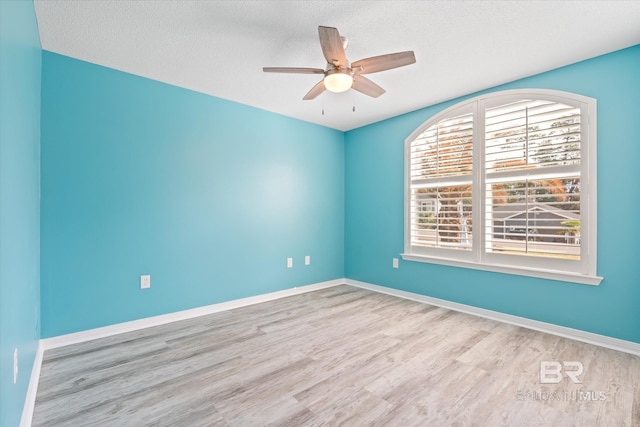 26715 Terry Cove Dr, Orange Beach, AL 36561 - spare room with wood finished floors, ceiling fan, a textured ceiling, and baseboards