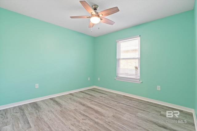 26715 Terry Cove Dr, Orange Beach, AL 36561 - spare room featuring wood finished floors, a ceiling fan, and baseboards