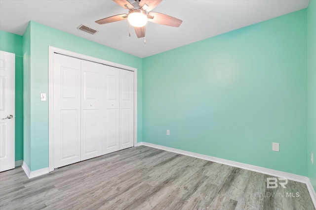 26715 Terry Cove Dr, Orange Beach, AL 36561 - unfurnished bedroom featuring wood finished floors, a closet, baseboards, and ceiling fan