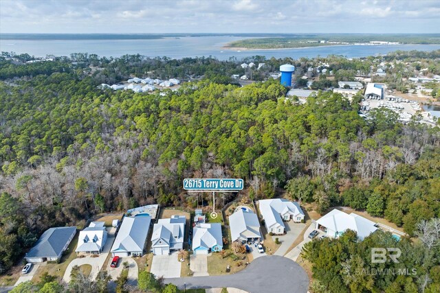 26715 Terry Cove Dr, Orange Beach, AL 36561 - aerial overview of property's location featuring nearby suburban area, a forest, and a large body of water