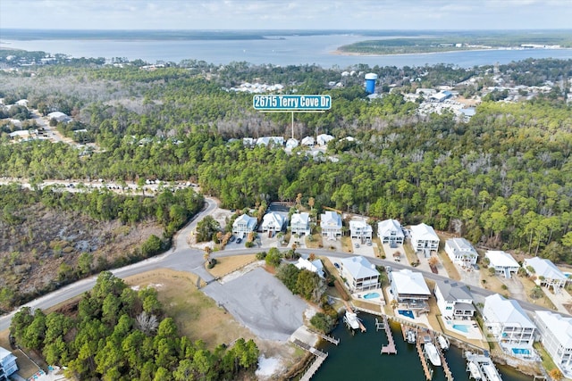 26715 Terry Cove Dr, Orange Beach, AL 36561 - aerial view of property's location featuring a large body of water, nearby suburban area, and a heavily wooded area