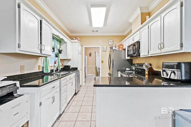 kitchen featuring light tile patterned flooring, kitchen peninsula, stainless steel appliances, and white cabinetry