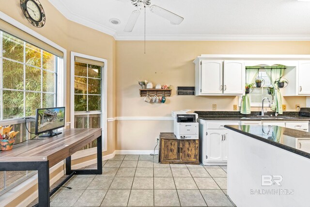 kitchen with ornamental molding, ceiling fan, sink, light tile patterned floors, and white cabinetry