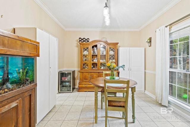 tiled dining room featuring crown molding and beverage cooler