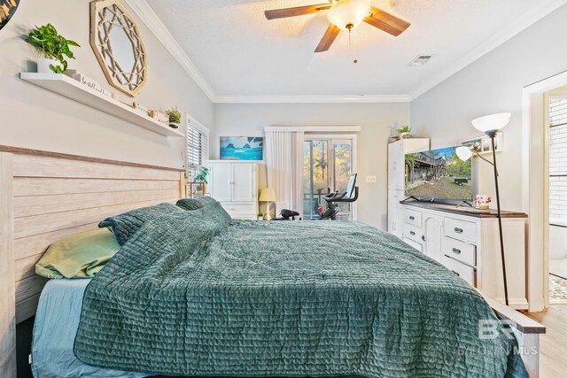 bedroom featuring a textured ceiling, ceiling fan, wood-type flooring, and crown molding