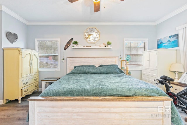 bedroom with hardwood / wood-style floors, ceiling fan, and ornamental molding