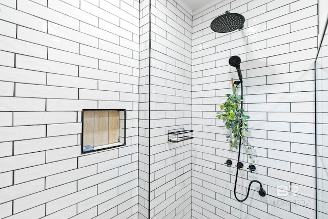 bathroom with a tile shower