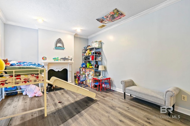 bedroom featuring crown molding, a textured ceiling, and hardwood / wood-style flooring