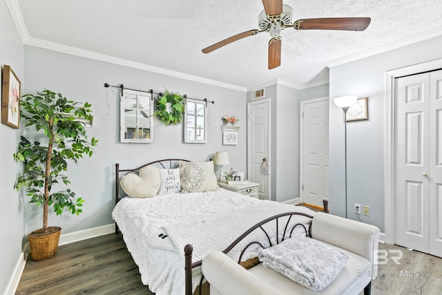 bedroom featuring ornamental molding, a textured ceiling, ceiling fan, and dark wood-type flooring