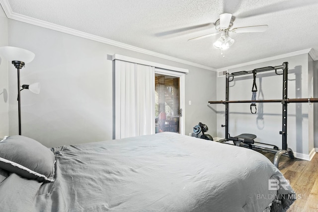 bedroom featuring hardwood / wood-style flooring, ceiling fan, crown molding, and a textured ceiling