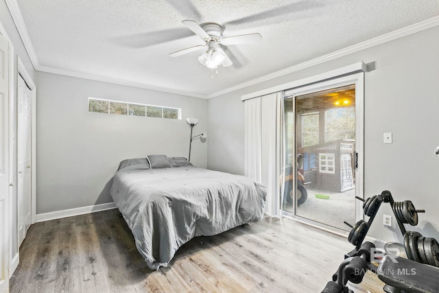 bedroom featuring ceiling fan, crown molding, access to outside, and multiple windows