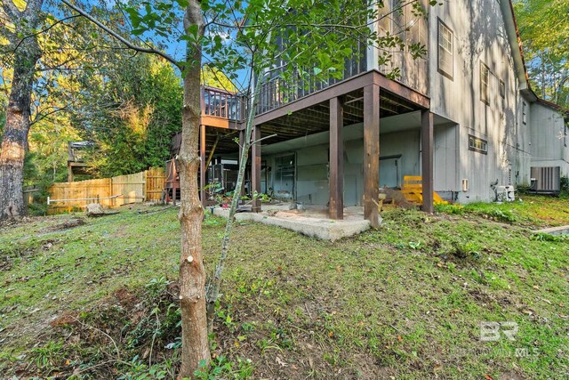 exterior space featuring central air condition unit and a wooden deck