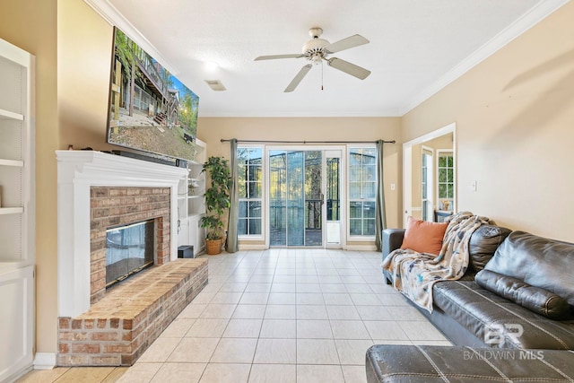 tiled living room featuring a brick fireplace, ceiling fan, and crown molding