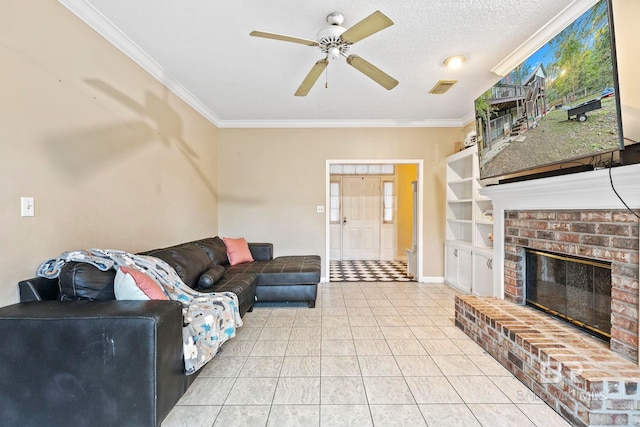 tiled living room featuring a textured ceiling, ceiling fan, ornamental molding, and a fireplace