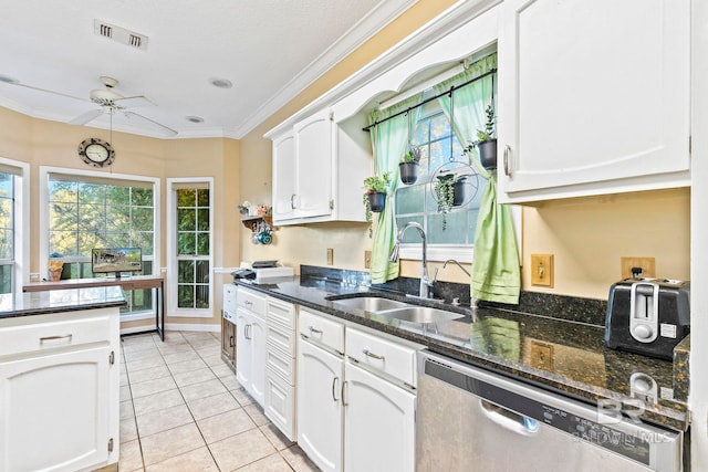 kitchen with dishwasher, white cabinetry, sink, and light tile patterned floors