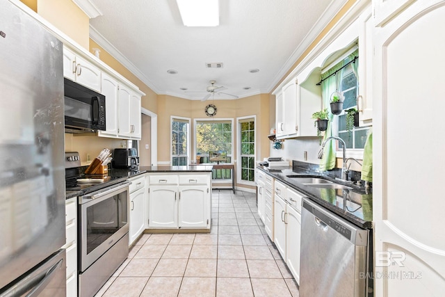 kitchen featuring white cabinets, kitchen peninsula, sink, and appliances with stainless steel finishes