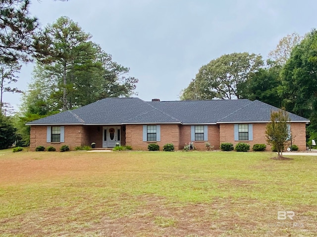 single story home featuring a front lawn