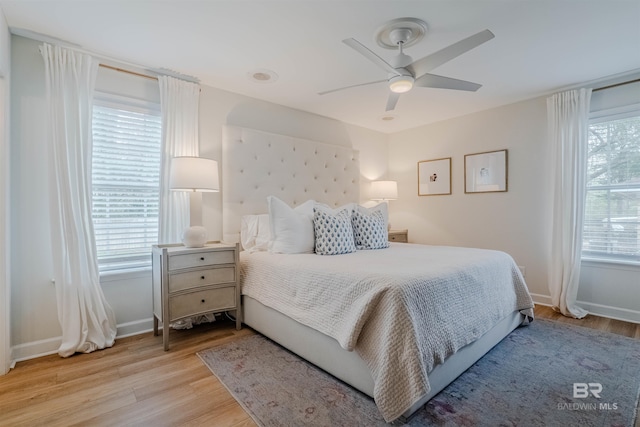 bedroom with light hardwood / wood-style flooring and ceiling fan