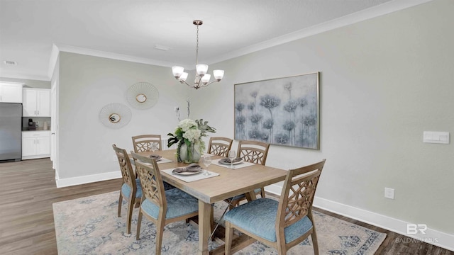 11529 Thistledown Loop, Spanish Fort, AL 36527 - dining area featuring ornamental molding, baseboards, a chandelier, and wood finished floors