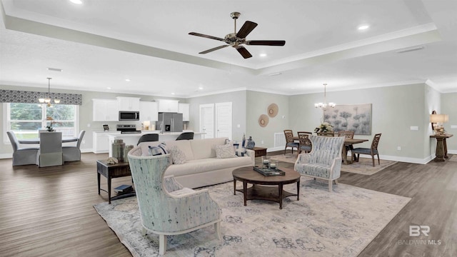 11529 Thistledown Loop, Spanish Fort, AL 36527 - living room featuring a chandelier, a tray ceiling, wood finished floors, baseboards, and recessed lighting