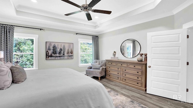 11529 Thistledown Loop, Spanish Fort, AL 36527 - bedroom featuring a tray ceiling, light wood-style flooring, multiple windows, and recessed lighting