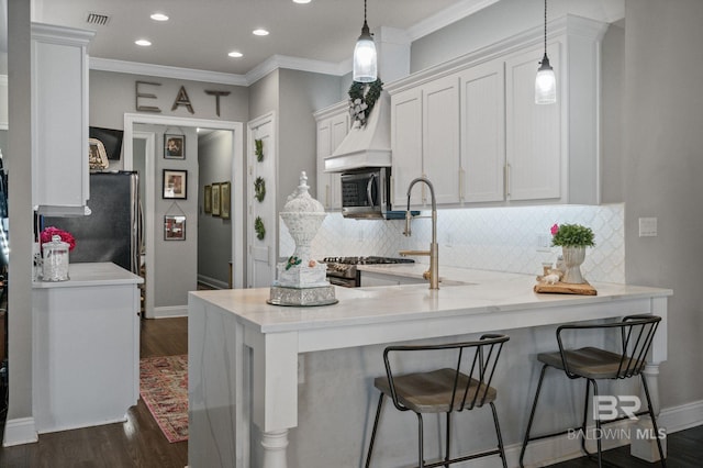 kitchen featuring dark wood-type flooring, visible vents, white cabinets, light countertops, and appliances with stainless steel finishes