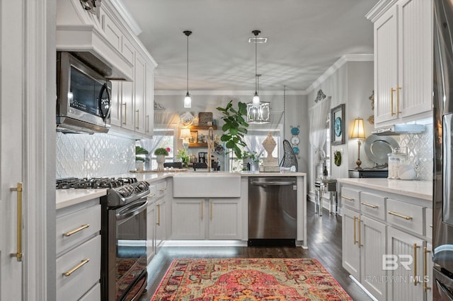 kitchen with appliances with stainless steel finishes, ornamental molding, dark wood-type flooring, hanging light fixtures, and backsplash