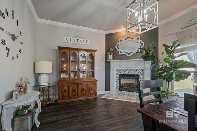 living area featuring ornamental molding, wood finished floors, a tile fireplace, and baseboards