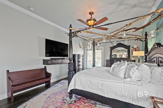 bedroom featuring baseboards, wood finished floors, and crown molding