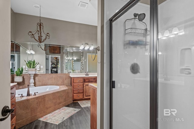 full bathroom featuring a garden tub, visible vents, a stall shower, vanity, and wood finished floors