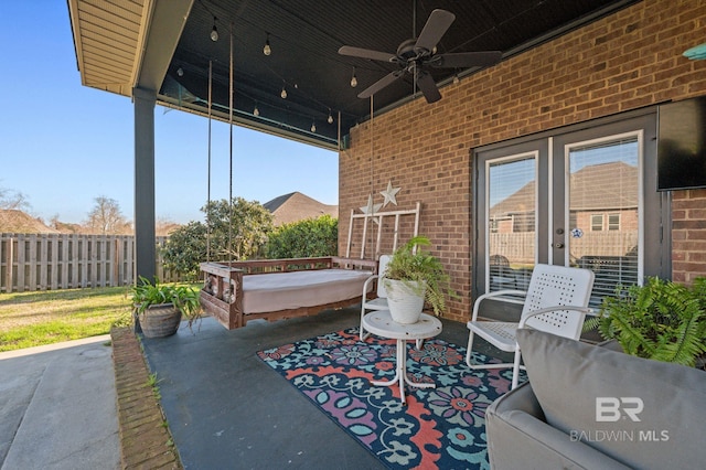 view of patio with fence and a ceiling fan