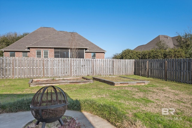 view of yard featuring a garden and a fenced backyard