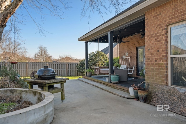 view of patio with a ceiling fan and fence