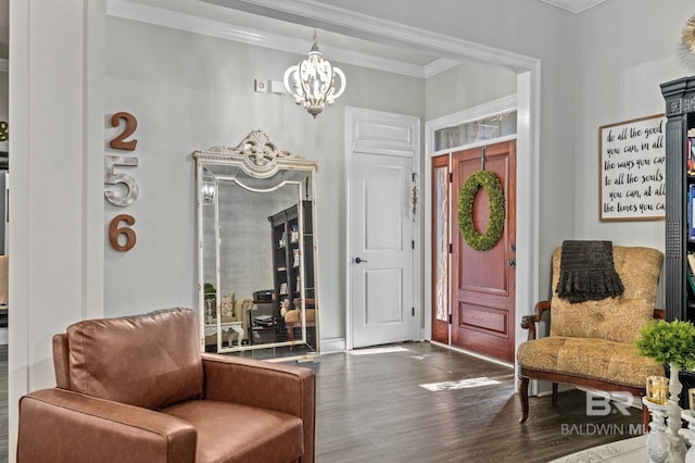 entryway featuring ornamental molding, an inviting chandelier, and wood finished floors