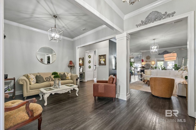 living room featuring decorative columns, visible vents, a notable chandelier, and wood finished floors